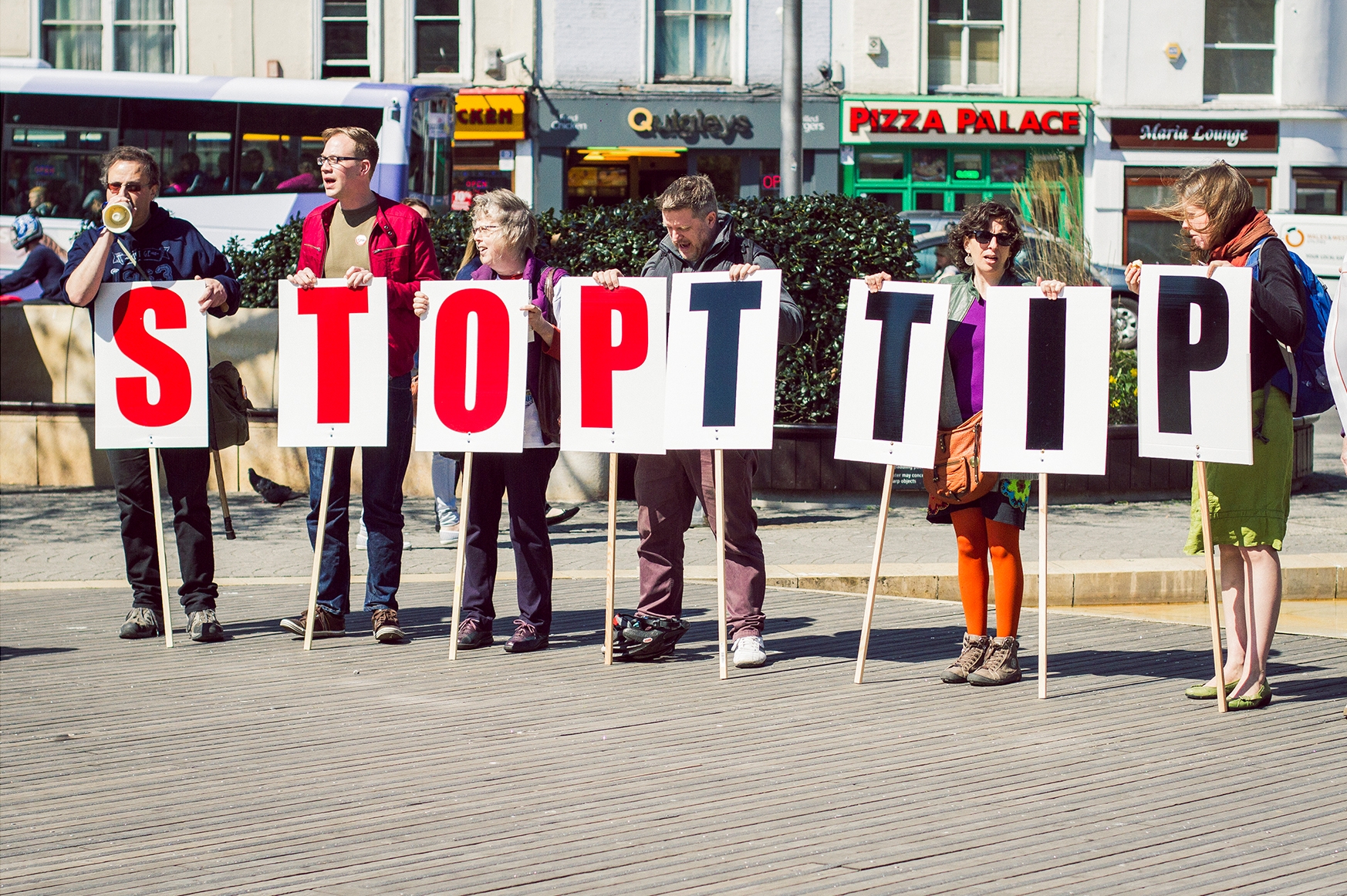 Protesters holding signs spelling ‘Stop TTIP’